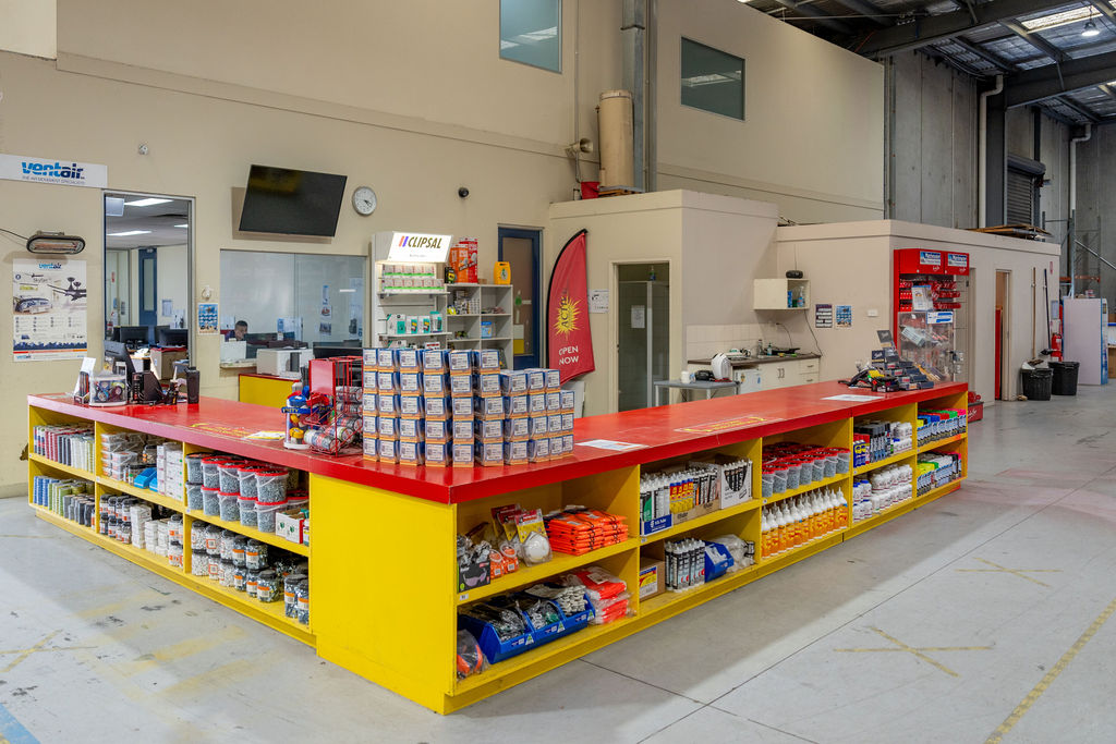 A Heimdall Power employee wearing security gear and smiling at the camera